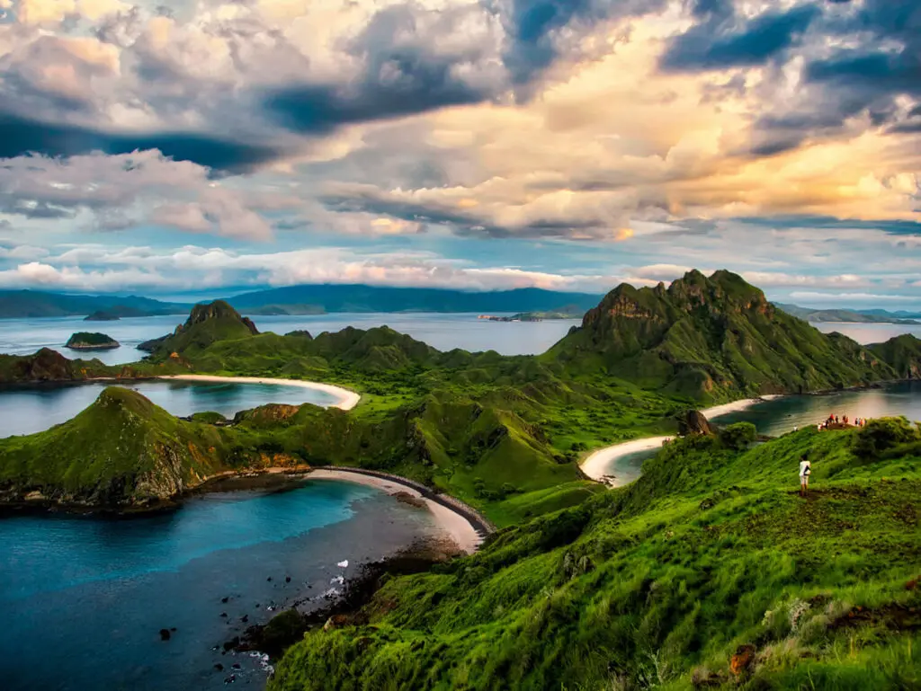 The vibrant green Komodo island during the wet season, contrasts with the blue ocean.